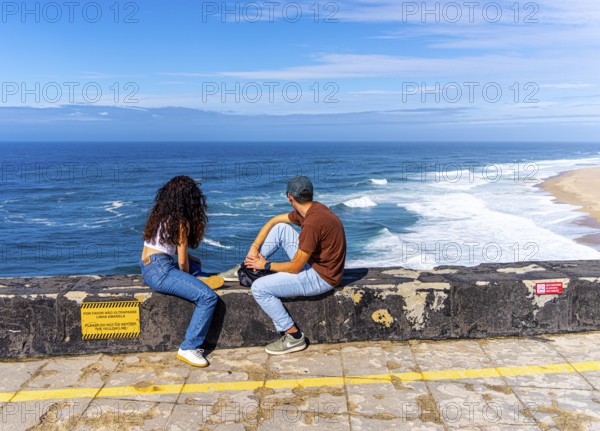 Tourists on the platform of Farol de Nazare lighthouse, Portugal