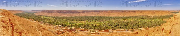 A panorama with an expansive green oasis and surrounding desert hills, Ziz Canyon in Morocco