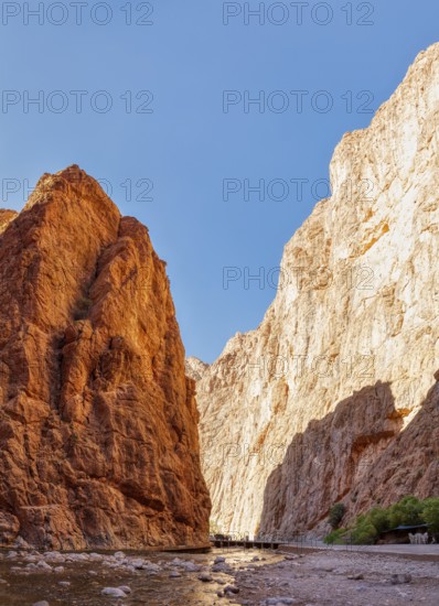 Deep rock gorge with a narrow stream and impressive stone structure, Todra Gorge in Morocco