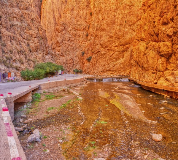 Impressive gorge with orange cliffs and a watercourse in the middle, Todra Gorge in Morocco