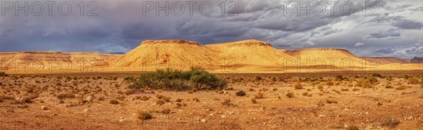 Extensive desert panorama with sandy hills and a cloudy sky, Tinghir in Morocco