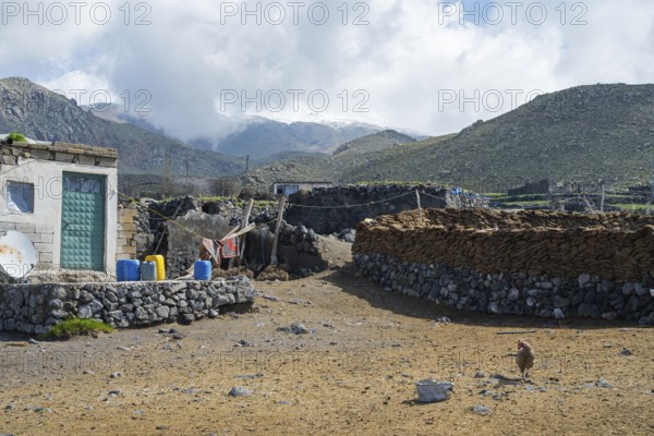 A simple stone building with mountains in the background, village at the foot of Great Ararat with wall of stones and cow dung, Büyük Agri Dagi, Cevirme, Çevirme, Dogubayazit, Dogubayazit, Dogubeyazit, Agri, Eastern Anatolia, Anatolia, Turkey