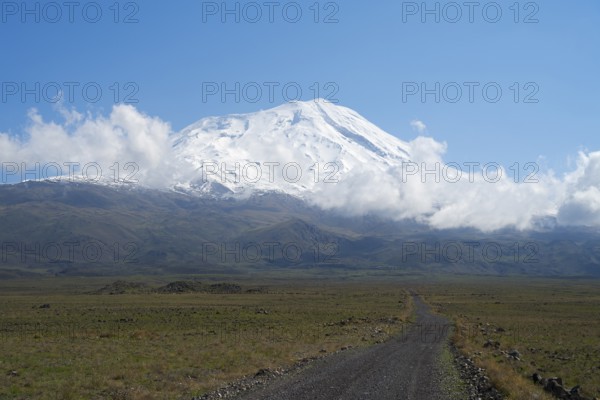A snow-covered mountain under blue sky with a path in the foreground, near Cevirme, Great Ararat, Büyük Agri Dagi, Dogubayazit, Dogubeyazit, Agri Province, Agri, Eastern Anatolia, Turkey, Asia near Cevirme, Asia