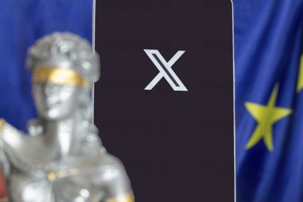 Symbolic picture of the EU Commission's fine against X: Justice, smartphone with logo of X and EU flag