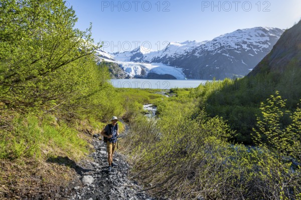 Hikers on the Portage Pass Trail, snowy mountains, Portage Glacier and Portage Lake, near Whittier, Alaska, USA
