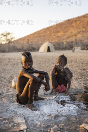 Himba children at the fire early in the morning, traditional Himba village, Kaokoveld, Kunene, Namibia