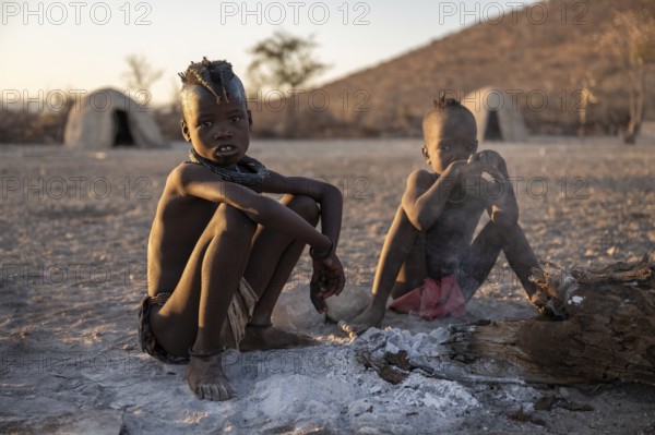 Himba children at the fire early in the morning, traditional Himba village, Kaokoveld, Kunene, Namibia