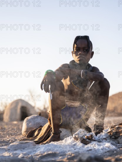 Himba child at the fire early in the morning, traditional Himba village, Kaokoveld, Kunene, Namibia