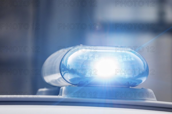 Symbolic image police operation: close-up of a blue light on a police car (digitally reworked)