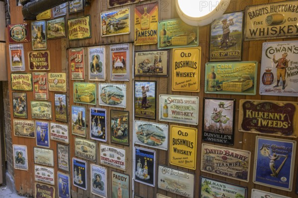 Wall with tin billboards in a whiskey shop, Dublin, County Dublin, Ireland