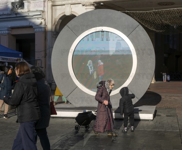 People on the Cornhill in the town centre view the first ever UK Portal in Ipswich, Suffolk, England, UK