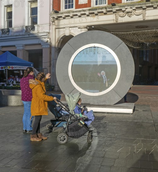 People on the Cornhill in the town centre view the first ever UK Portal in Ipswich, Suffolk, England, UK