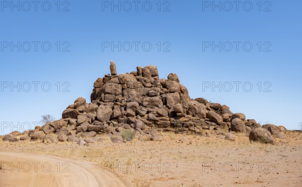 Round spherical rocks stacked into hills, Brandberg, Damaraland, Erongo, Namibia