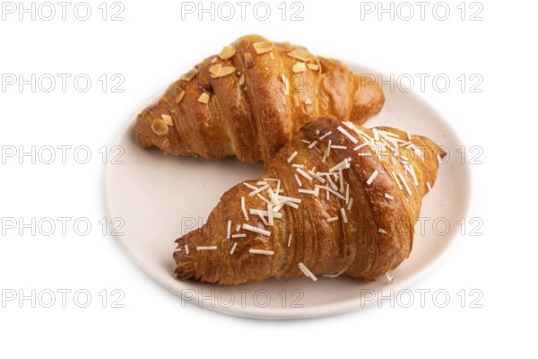 Croissant on white plate isolated on white background, side view, close up