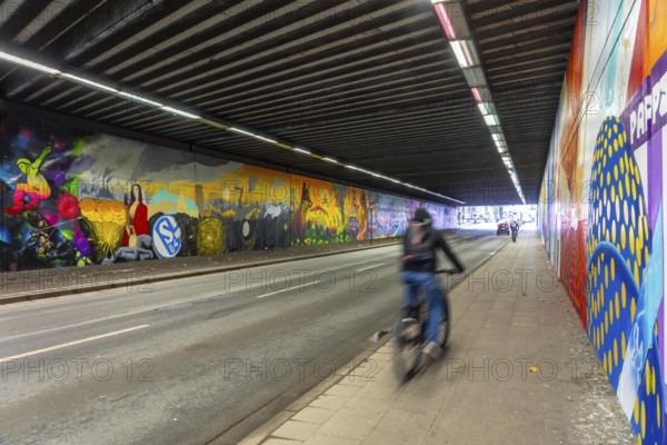 Huge street art pictures in a road tunnel in Gelsenkirchen, the approximately 120 meter long railway underpass of Wickingstraße was extensively painted and sprayed on both sides by 11 Gelsenkirchen graffiti artists and collectives, over a total length of 174 meters, the wall paintings showed motifs from Gelsenkirchen history, from economy, coal, steel, soccer, Schalke 04, culture, life, to the 150.year-old city Anniversary on 29.11.25, North Rhine-Westphalia, Germany