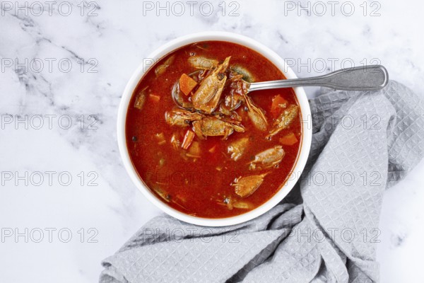 French shrimp bisque soup, on a marble table, close-up, no people