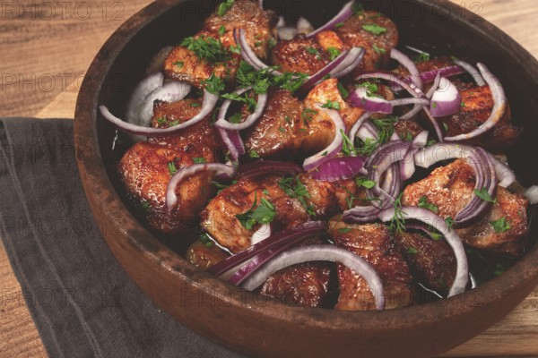 Fried meat, pork kebab, ketsi in a clay pan, with red onions and herbs, homemade, no people