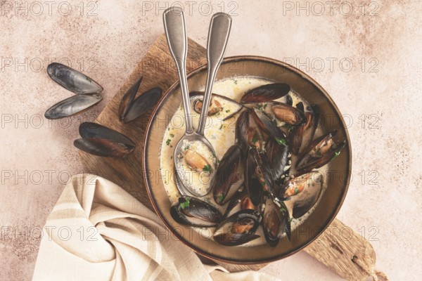 Mussels in creamy garlic sauce, served with fresh herbs and spices, homemade, no people