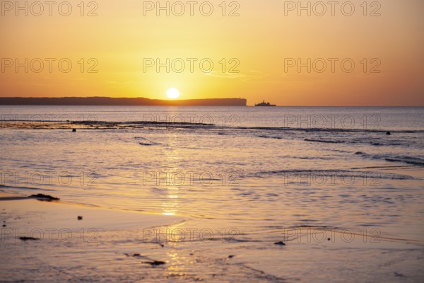 Sunrise over Jervis Bay — View of Point Perpendicular lighthouse. A ship on the horizon