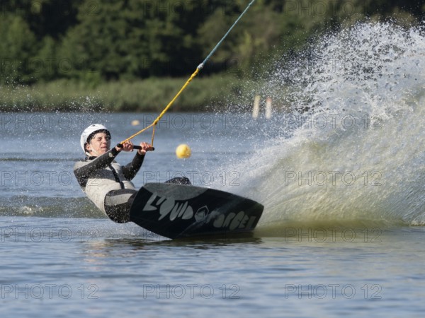 Young man with wakeboard, sporty on water, athletic model, active water sports, wake park
