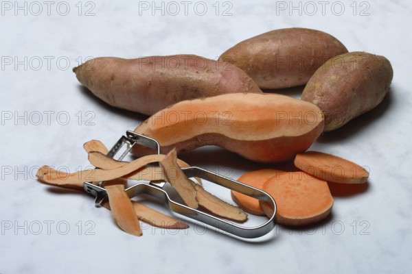 Sweet potatoes with potato peeler, Ipomoea batatas