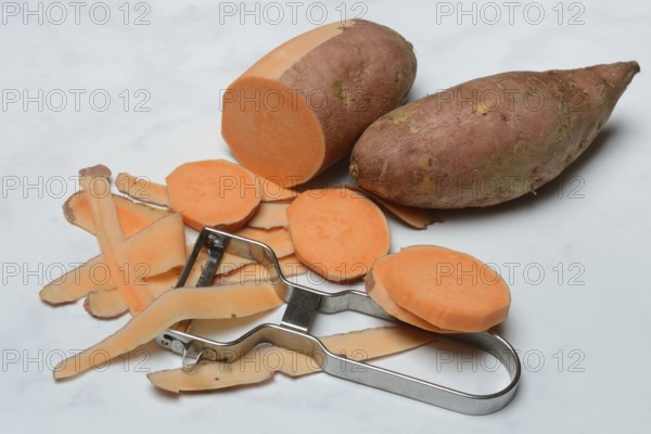 Sweet potatoes with potato peeler, potato slices, partially peeled, Ipomoea batatas