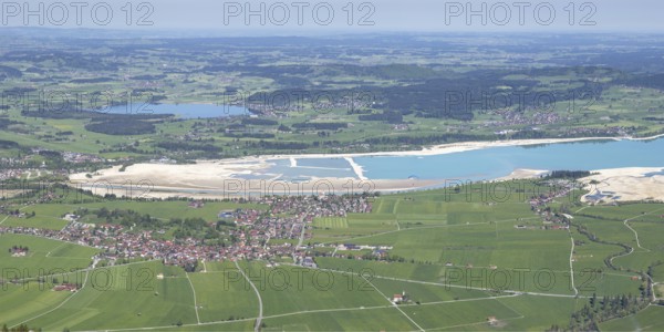 Panorama in spring from Tegelberg, 1881m, of Schwangau, Waltenhofen, Hopfensee and the partly still drained Forggensee, Ostallgäu, Bavaria, Germany