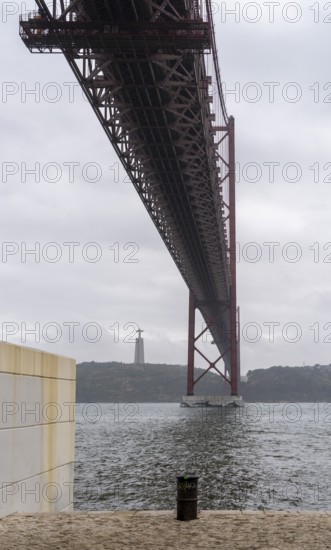 The Ponte 25 de Abril, 3.2 km long bridge in Portugal with a 2278 meter long suspension bridge across the Tagus, cloudy and rainy weather, third-longest suspension bridge with combined road and rail traffic, Lisbon, Portugal