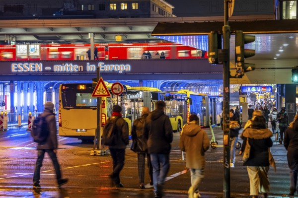 The main train station in Essen, blue illuminated underpass, bus station, am Europaplatz, train on the platform, pedestrian crossing, North Rhine-Westphalia, Germany