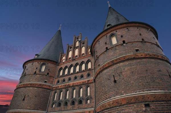 Holstentor, historic city gate from 1478, evening sky, Holstentorplatz, Hanseatic City of Lübeck, Schleswig-Holstein, Germany