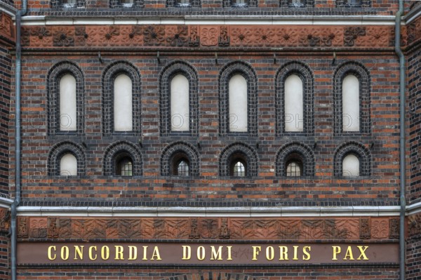 Concodia Domini Fotris Pax: The harmony of the Lord, the peace of the father, a saying at the Holsten Gate, historic city gate from 1478, Holstentorplatz, Hanseatic City of Lübeck, Schleswig-Holstein, Germany