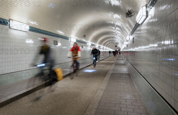 Interior view, pedestrians and cyclists crossing tunnel, mopping effect, movement, tube, historic old Elbe Tunnel, Free and Hanseatic City of Hamburg, Germany