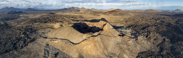 Volcán de Las Nueces volcano, picturesque volcanic landscape with volcanic craters and lava fields in morning light, Parque Natural de Los Volcanes, aerial view, Lanzarote, Canary Islands, Spain