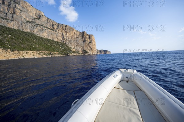 Motorboat trip along the picturesque rocky coast, cliffs and blue sea, Golfo di Orosei, Baunei, Sardinia, Italy