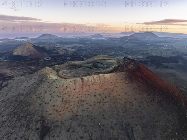 Caldera Colorada volcano, picturesque volcanic landscape with volcanic crater at sunrise, Parque Natural de Los Volcanes, aerial view, Lanzarote, Canary Islands, Spain
