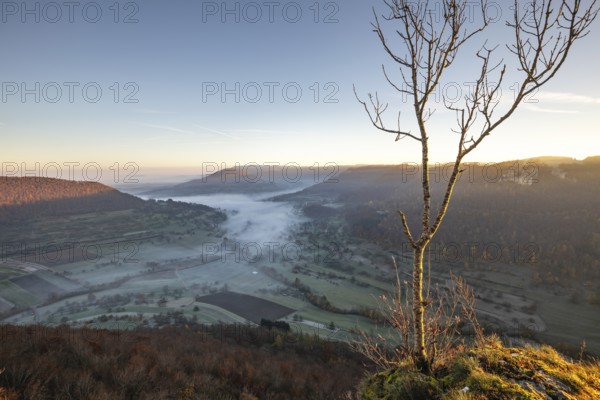 Sunrise with fog in the Neidlinger Valley with a view of the Reussenstein castle ruins. Swabian Jura, Baden-Württemberg, Germany