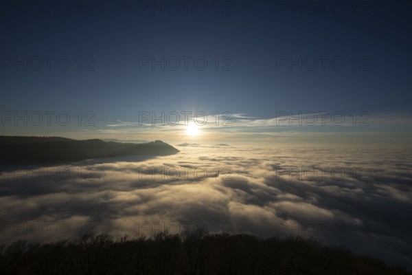 Sunset over the sea of fog from Beurener Fels to Hohenneuffen Castle, Swabian Alb, Baden-Württemberg, Germany