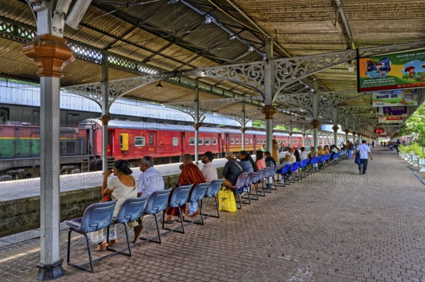 People waiting on the train platform, Kandy Railway Station, Sri Lanka