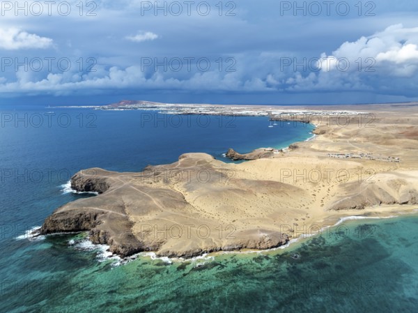 Coast with Playa de Papagayo beach and Playa Caleta del Congrio and blue sea, dry landscape of Los Ajaches Natural Park, aerial view, Lanzarote, Canary Islands, Spain