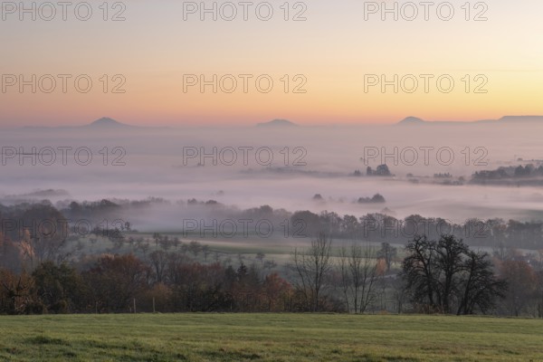 Three Kaiserberge mountains in golden morning light, Hohenstaufen, Aichelberg. Spectacular dawn over the foggy foothills of Baden-Württemberg