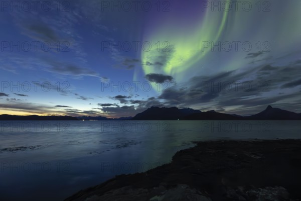 Northern lights at dawn over Sørfolda Fjord near Kjerringøy between Bodø and Sørfold in Norway