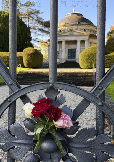 Roses at the fence door of the Carstanjen mausoleum in the Plittersdorf district, Bonn, North Rhine-Westphalia, Germany