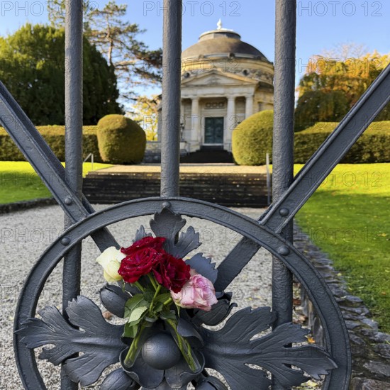 Roses at the fence door of the Carstanjen mausoleum in the Plittersdorf district, Bonn, North Rhine-Westphalia, Germany