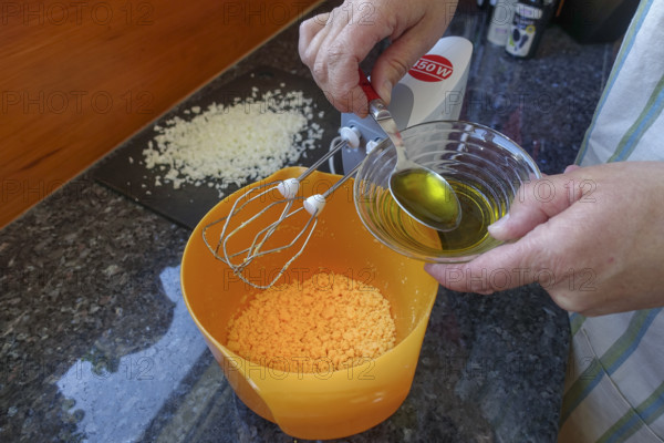 Southern German cuisine, preparing aioli, garlic cream, mayonnaise, oil and minced egg, men's hands, hand mixer, studio, food photography, Germany