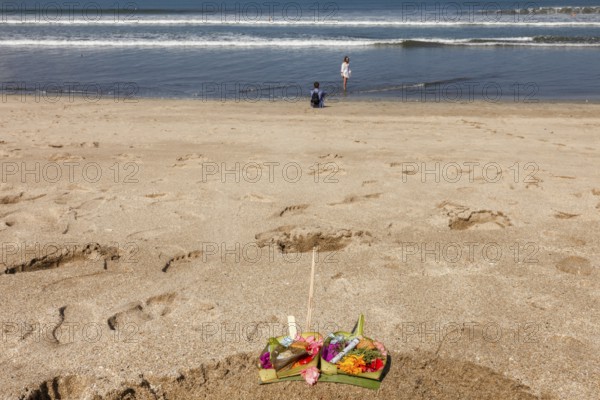 Canang Sari is a Balinese offering that expresses Wasa (God) or the creators of life to Sang Hyang Widhi. The offerings are used to balance and maintain peace on earth, between good and evil, between gods and demons, between heaven and hell, Kuta beach, Bali, Indonesia