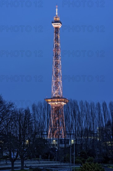Red illuminated Berlin radio tower, half-timbered steel building by architect Heinrich Straumer, Langer Lulatsch, old radio tower, television tower, heritage-protected building, exhibition center, Messe Berlin, dusk, blue hour, Berlin, Germany