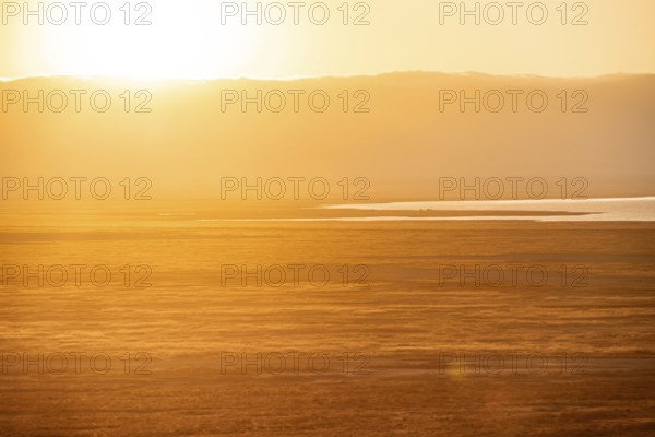 View of savanna landscape at sunrise, atmospheric morning light, view of Ngorongoro Crater, back light, Ngorongoro Conservation Area, Tanzania