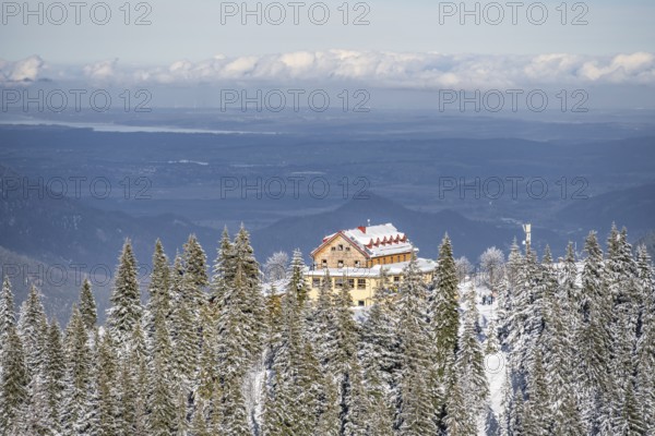 Snowy forest and Kreuzeckhaus mountain hut in the Garmisch Classic ski area in winter, Wetterstein Mountains, Garmisch-Partenkirchen, Bavaria, Germany