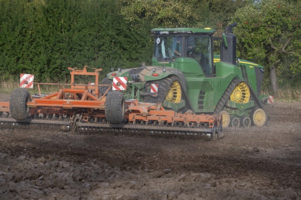 Crawler tractors harrow the field, Othenstorf, Mecklenburg-Western Pomerania, Germany