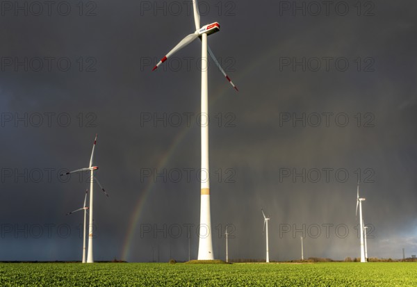 Königshovener Höhe onshore wind farm, on the A44 motorway near Bedburg, in front of the Jackerath triangle, autumn, rainbow, dark rain clouds, recultivated open-cast mining area, Garzweiler open-cast lignite mine, operated by RWE and the city of Bedburg, North Rhine-Westphalia, Germany